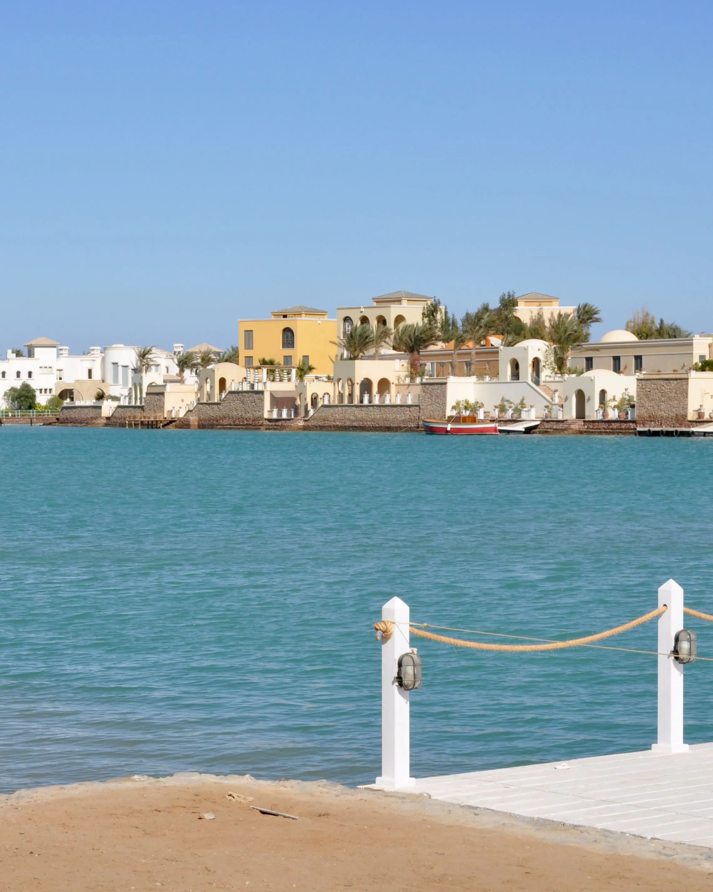 Lagoon-side villas at El Gouna on the Red Sea, seen across the water from a jetty