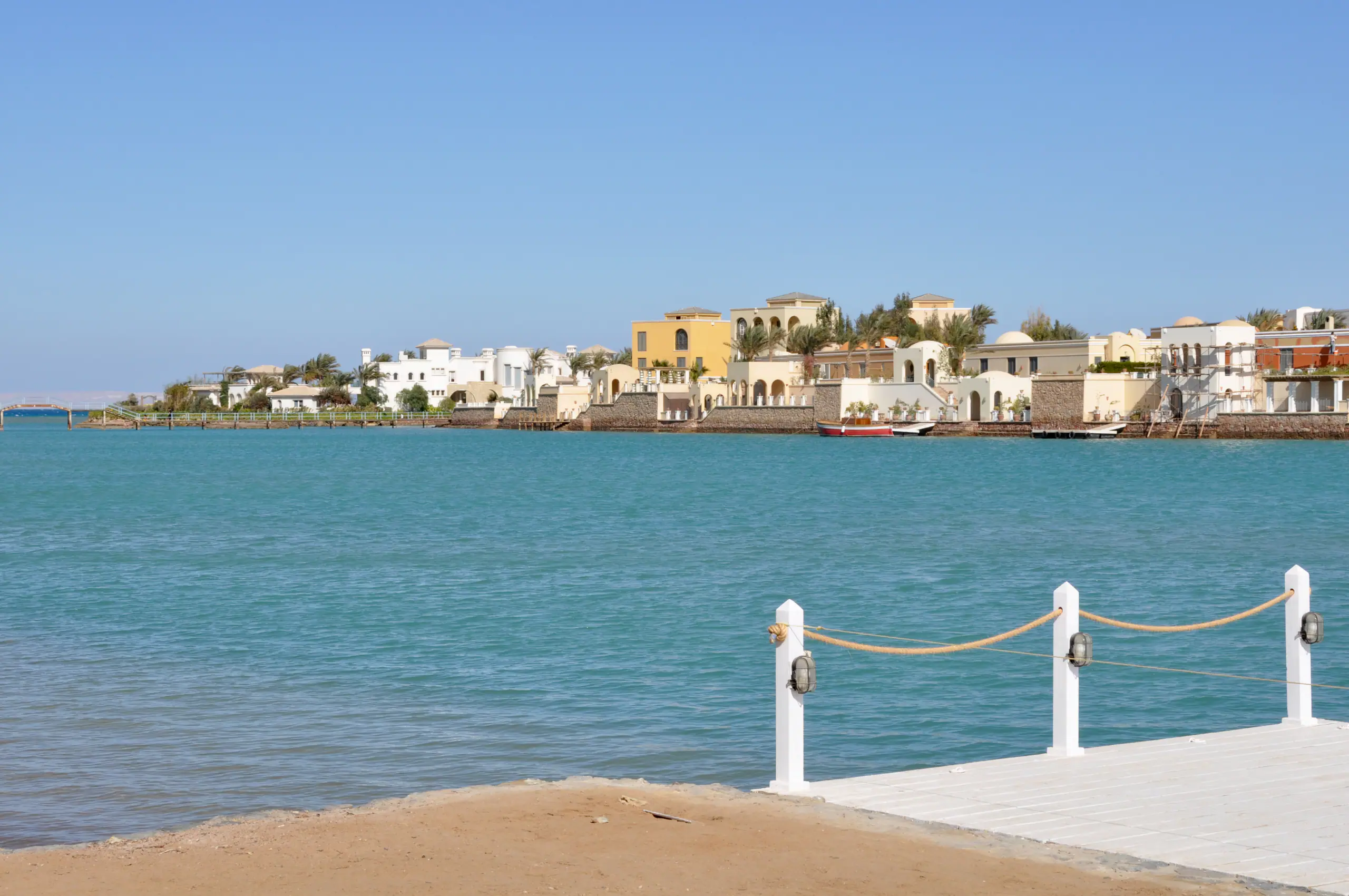 Lagoon-side villas at El Gouna on the Red Sea, seen across the water from a jetty