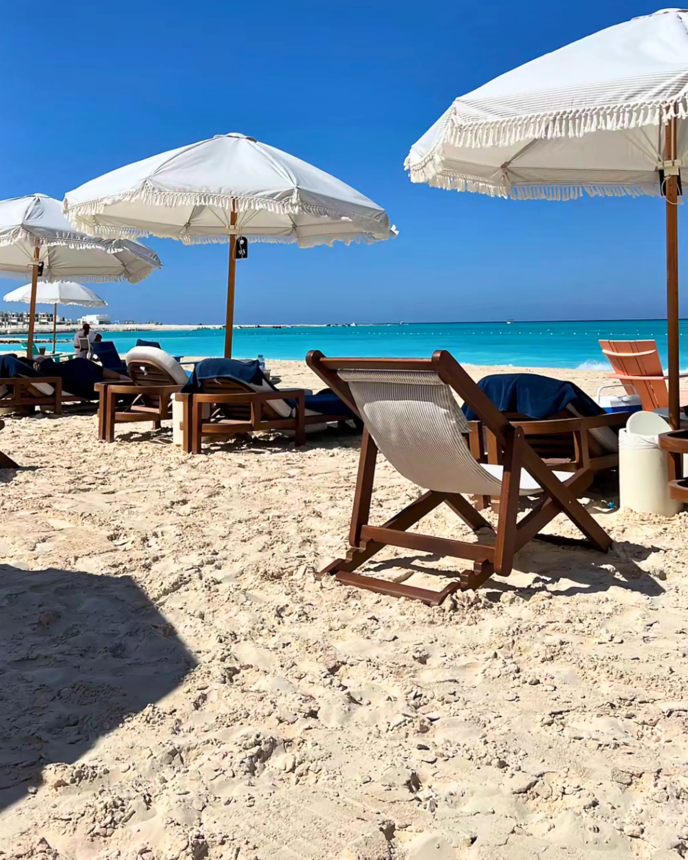 Parasols and loungers on a white-sand beach