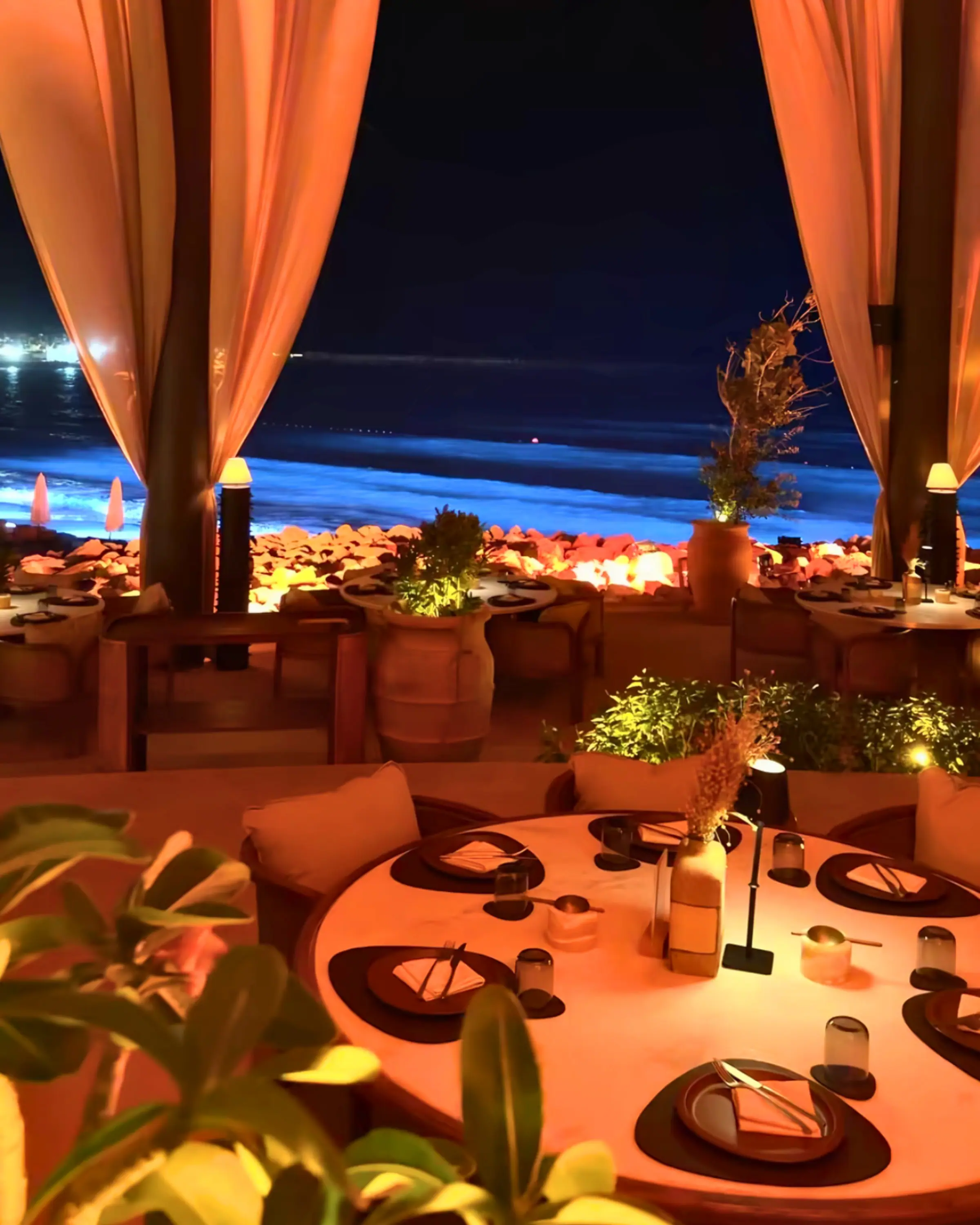 A candlelit terrace set for dinner at night