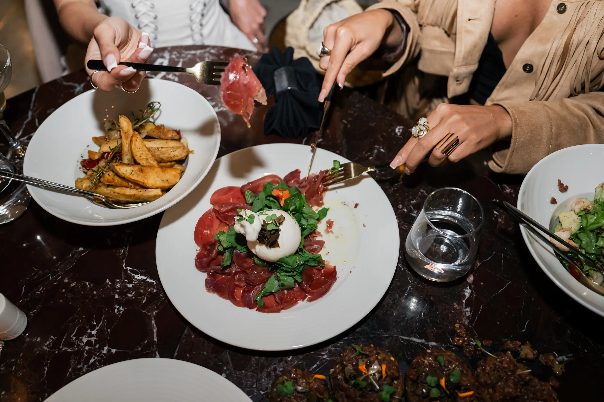 Plates shared across a marble table at Pier 88, Pyramid Hills