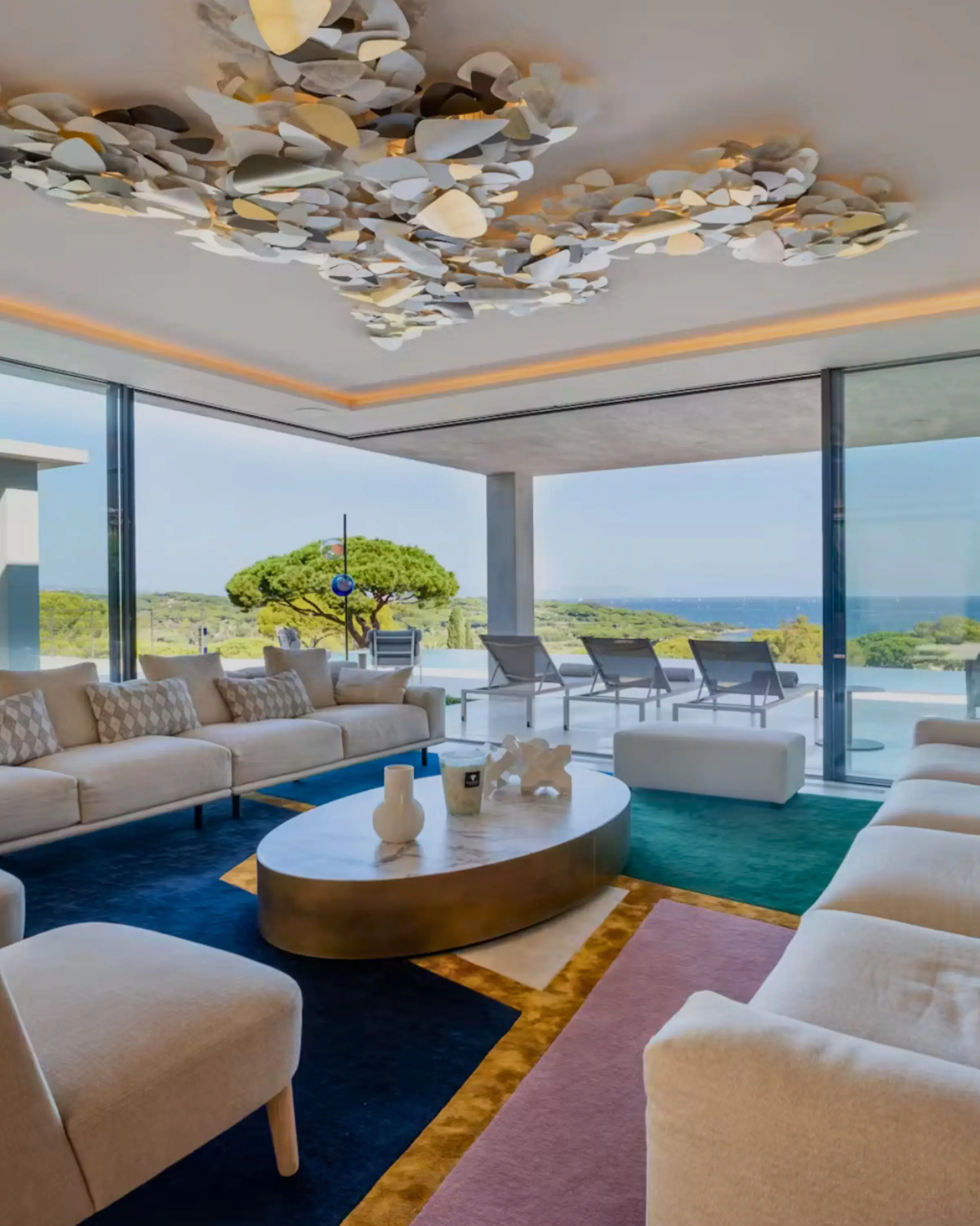 A villa living room opening onto pines and the sea